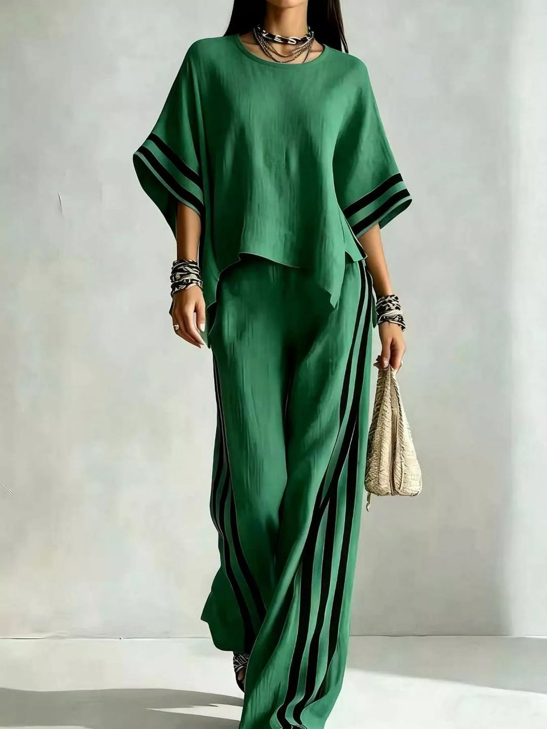 Green wide sleeve top and striped pants set, front view with a woven bag