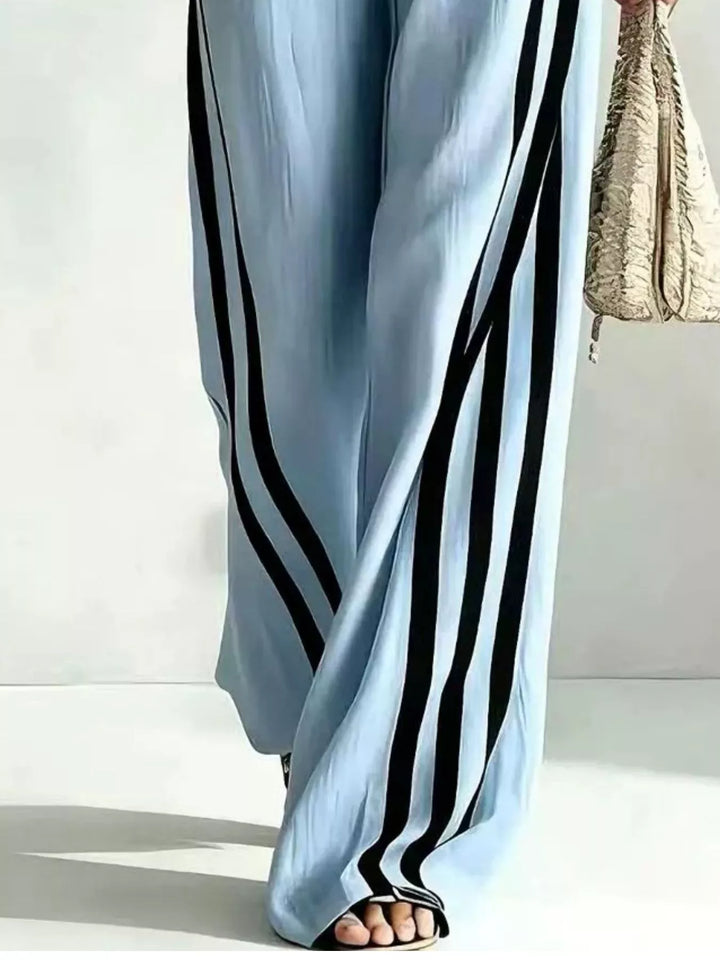 Detail of the light blue wide leg pants with black side stripes