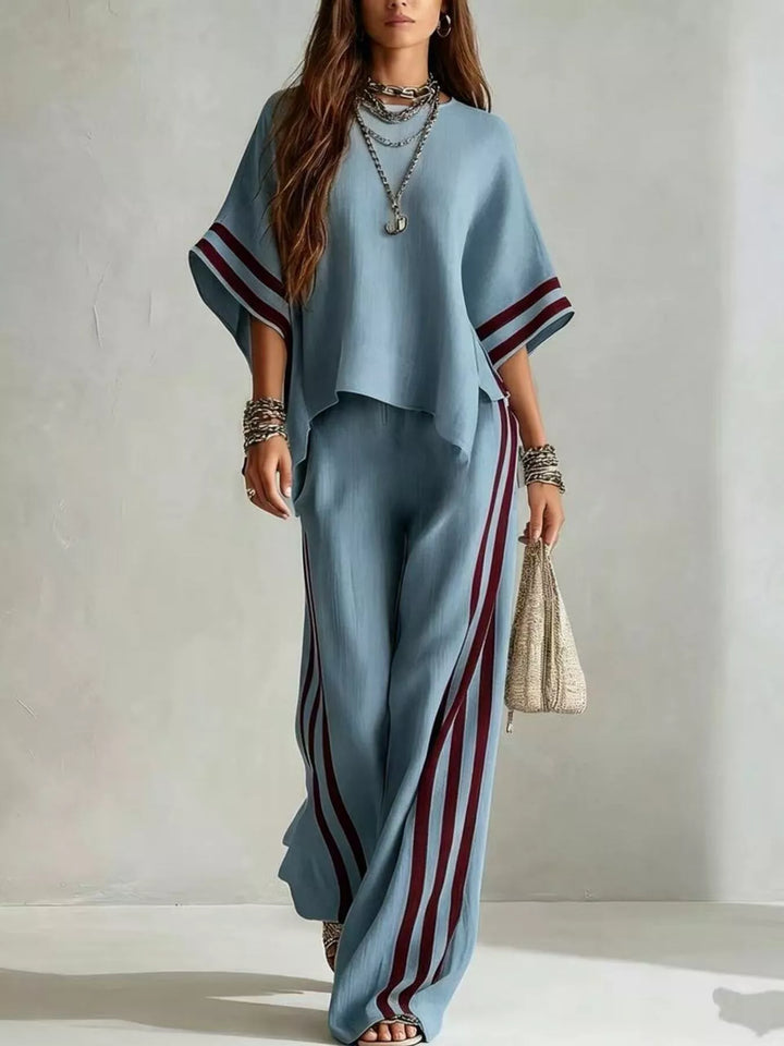 Steel blue wide sleeve top with burgundy striped pants, front view