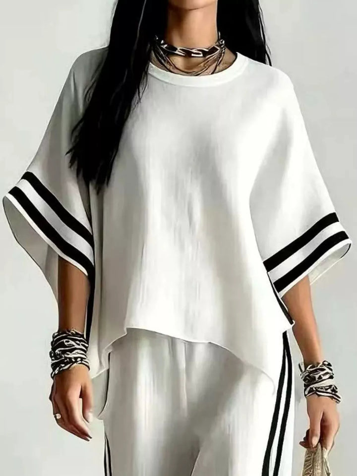 Close-up of the white wide sleeve top with black striped sleeve trim