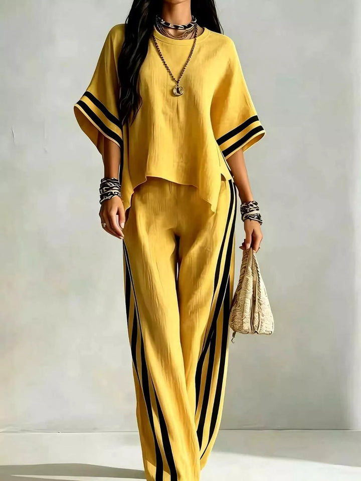 Yellow wide sleeve top with black striped wide leg pants, front view