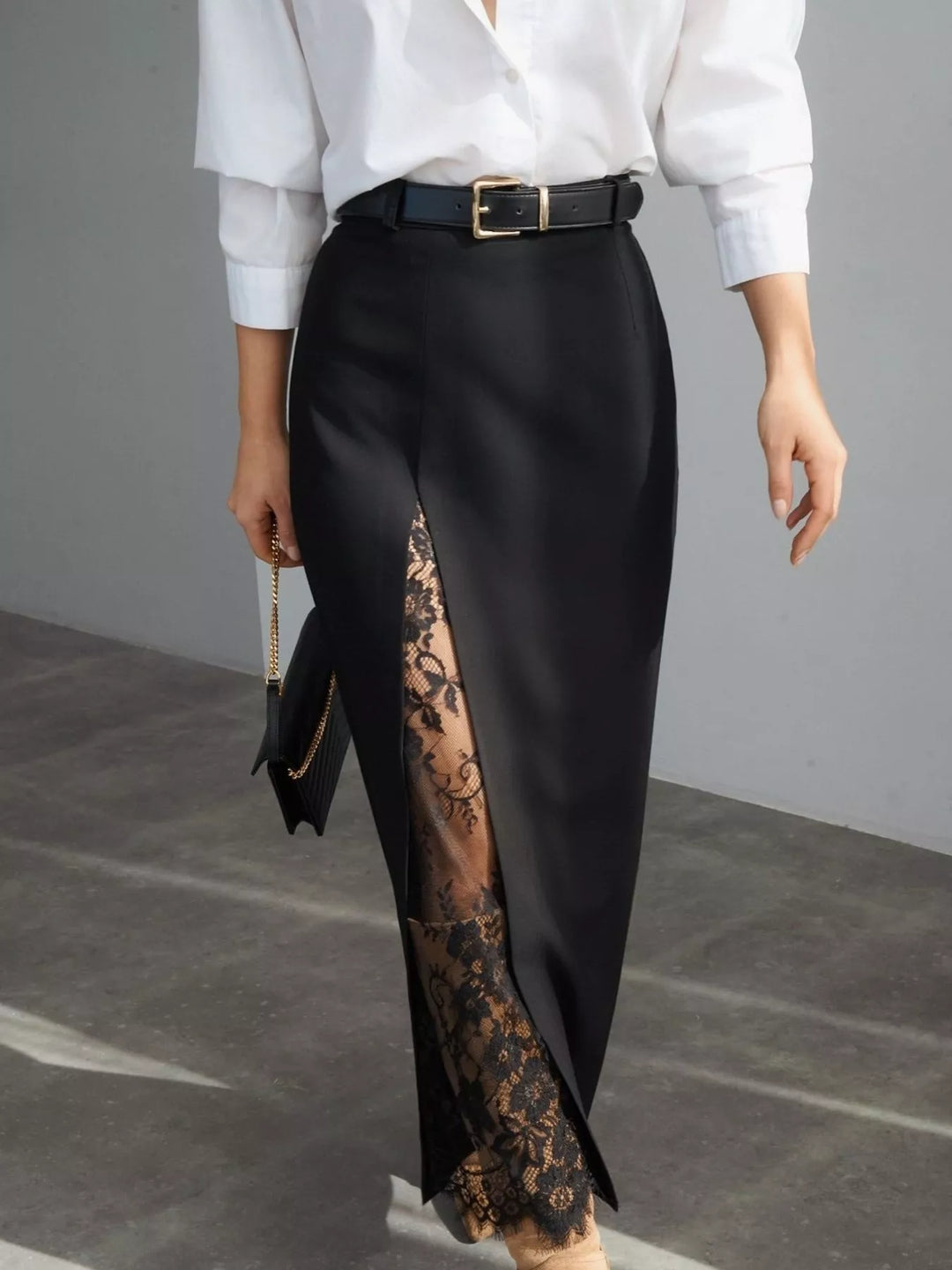 Black maxi skirt with a sheer lace front slit, worn with a white shirt