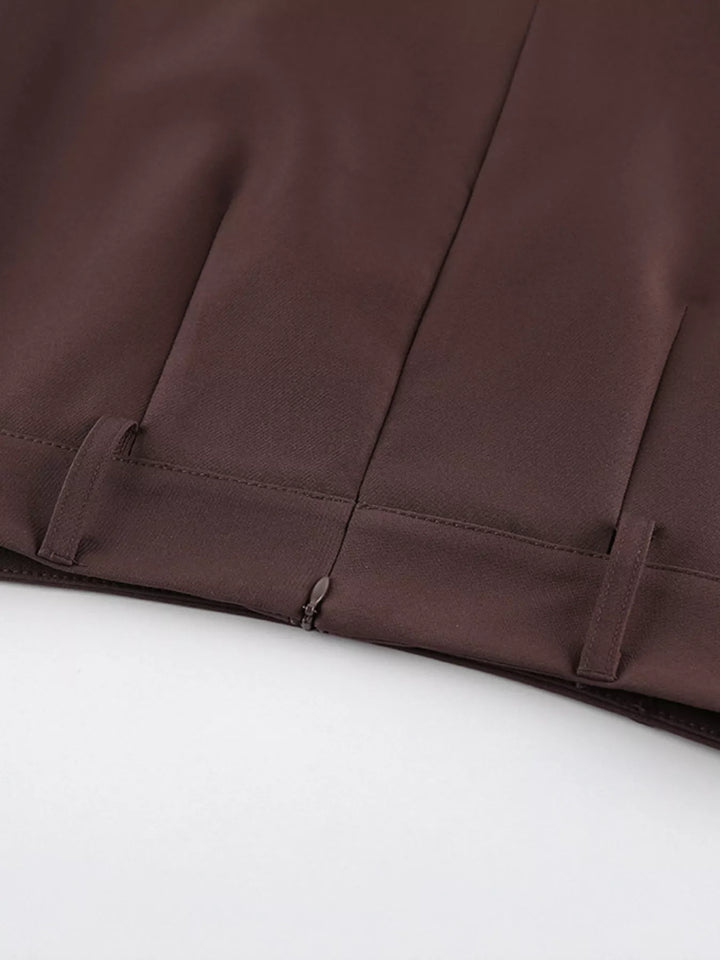 Close-up of the hidden zipper and pleat at the brown skirt waist