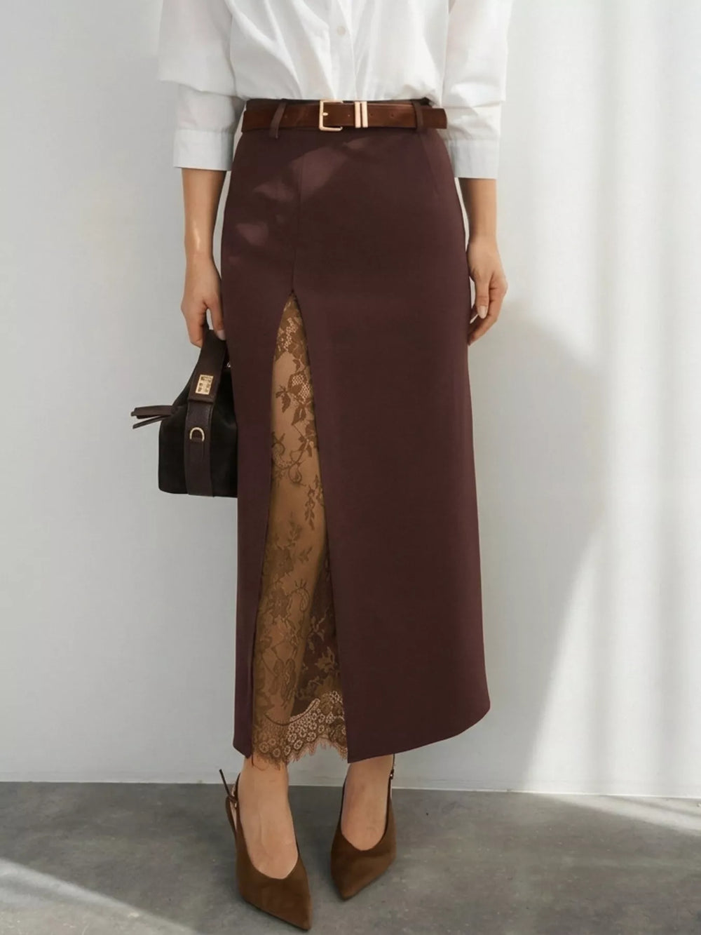 Chocolate brown maxi skirt styled with a white blouse, belt and pointed heels