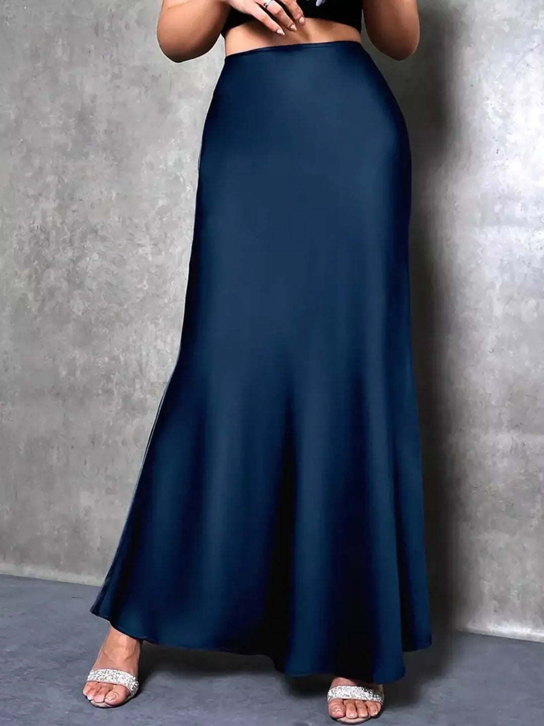 Front view of the peacock blue trumpet hem skirt flaring toward the ankles