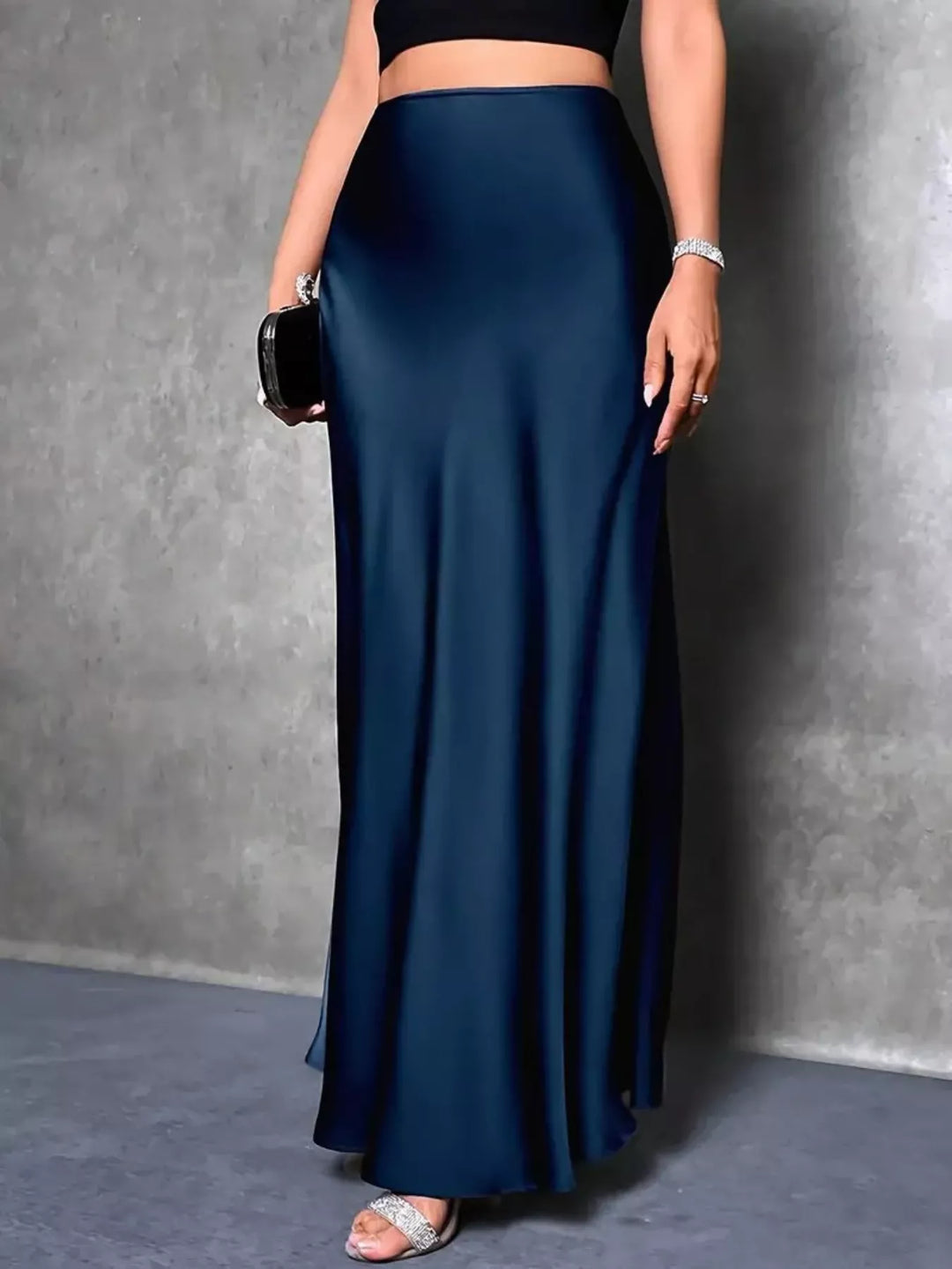 Side view of the peacock blue trumpet hem skirt with a black crop top