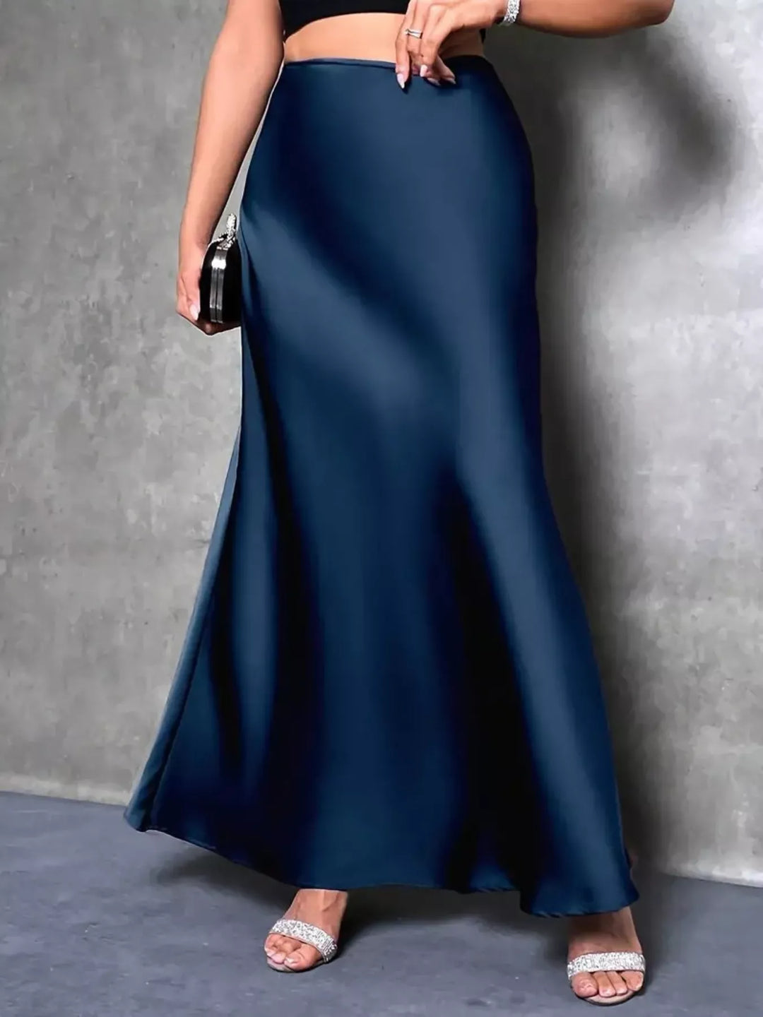 Peacock blue satin-look maxi skirt worn with strappy sandals, flared hem