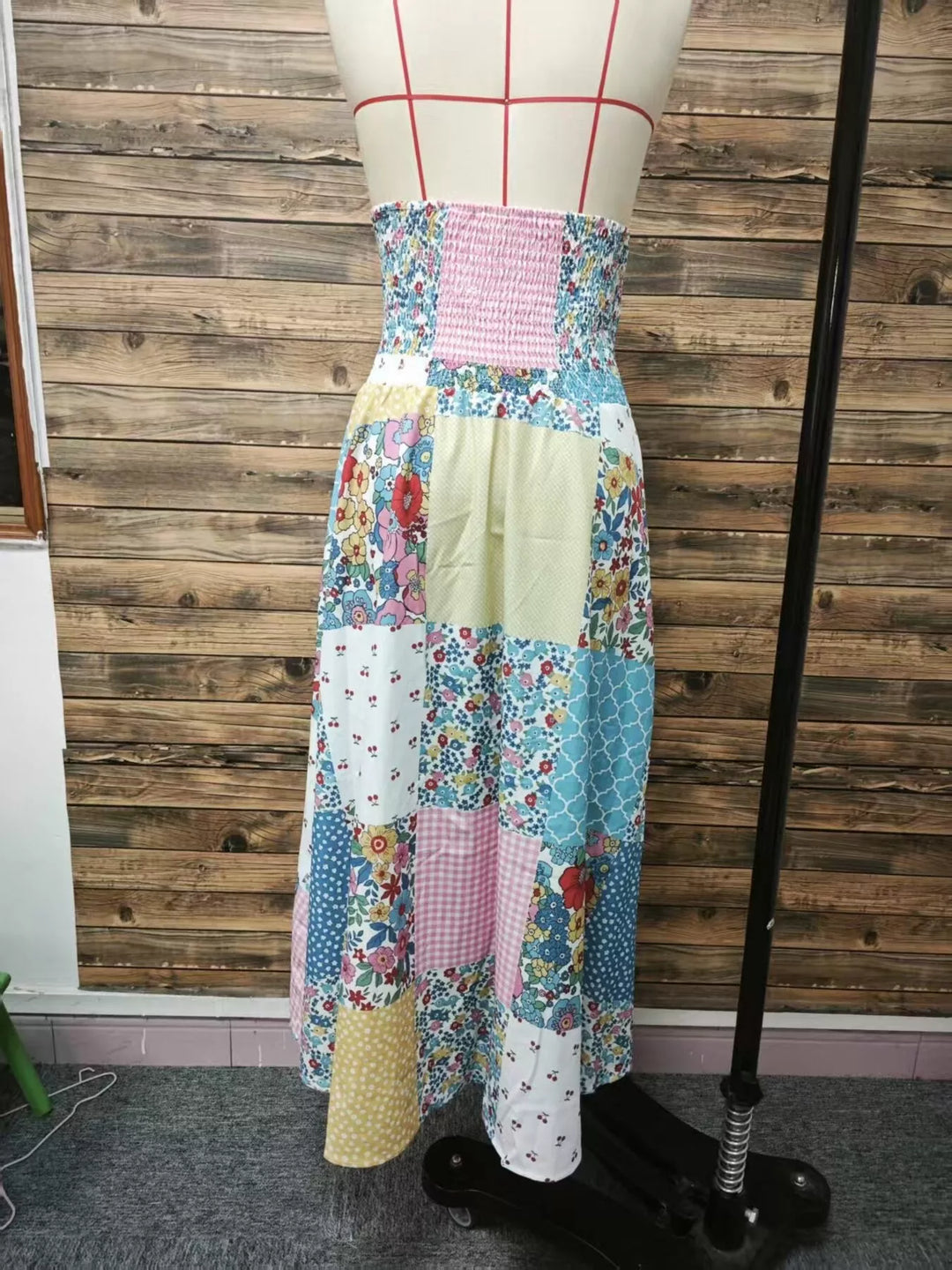 Back view of the smocked waist floral patchwork maxi skirt on a mannequin