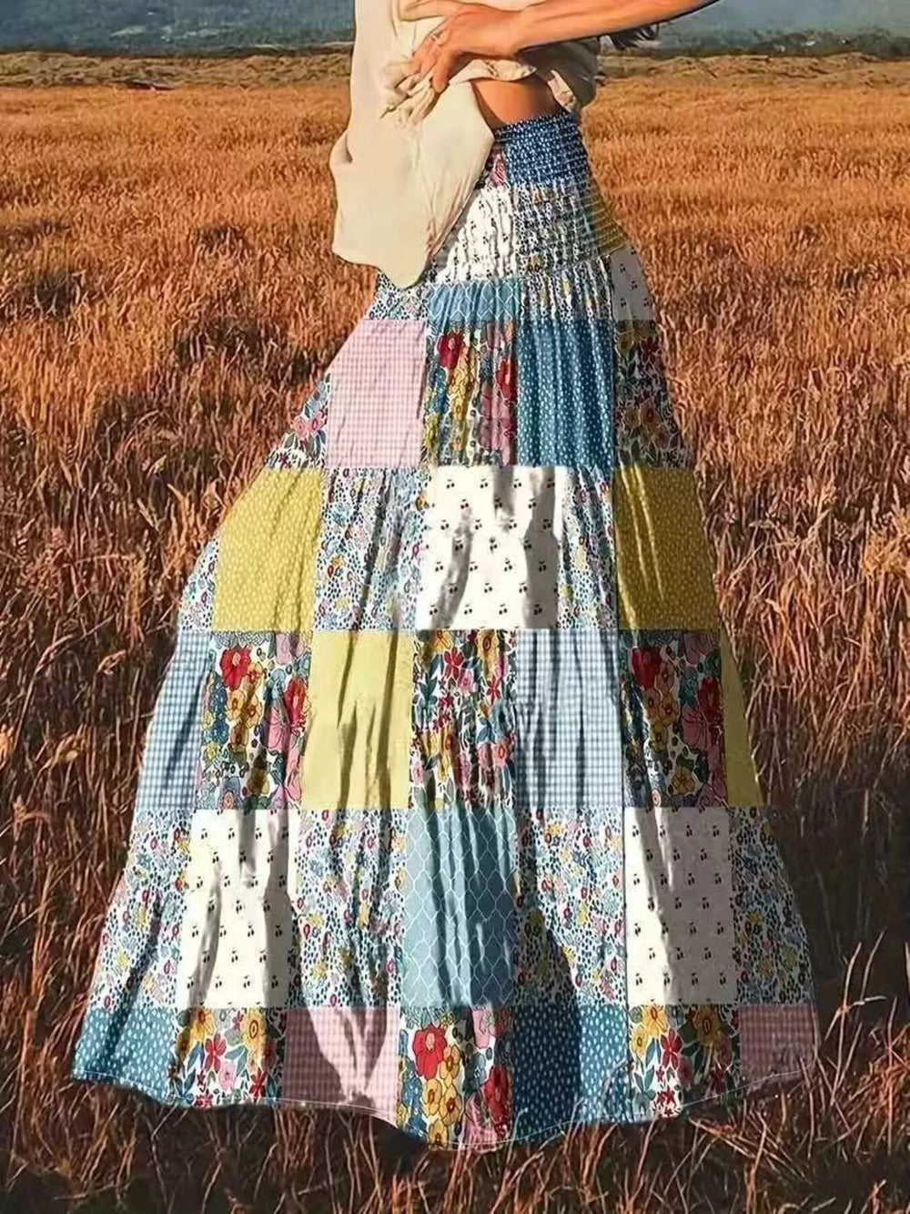 Tiered floral patchwork maxi skirt in a golden field, front view
