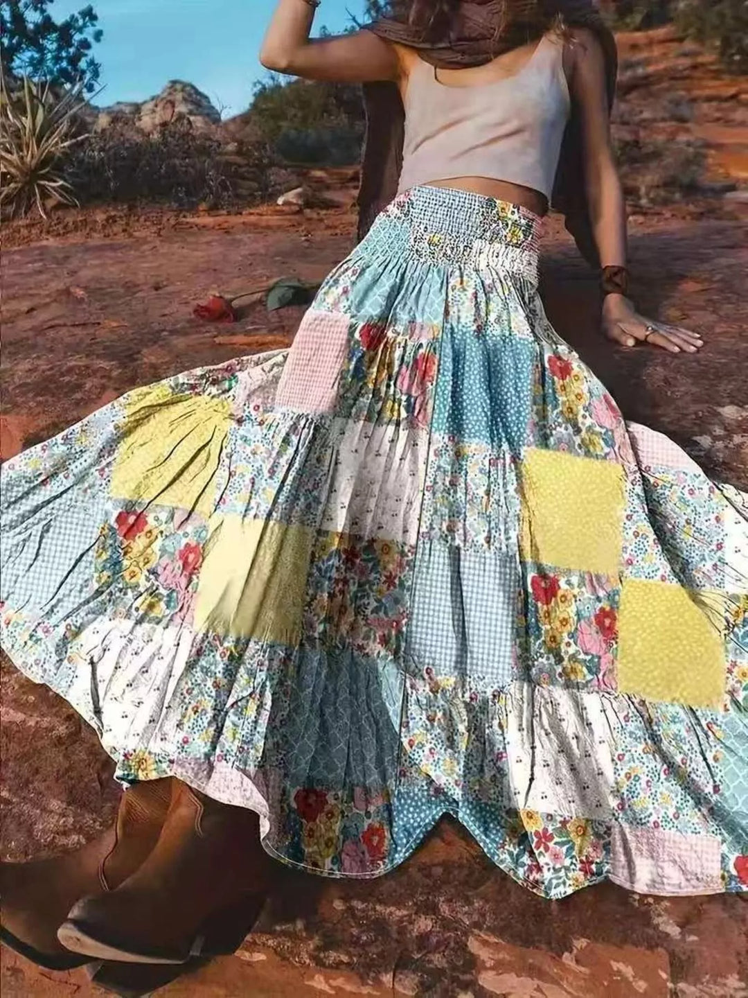 Women's maxi skirt in floral patchwork with tiered smocked waist, worn outdoors on red rock