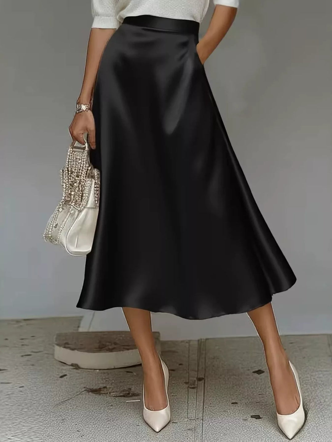 Black high waisted satin look A line midi skirt with a woven bag