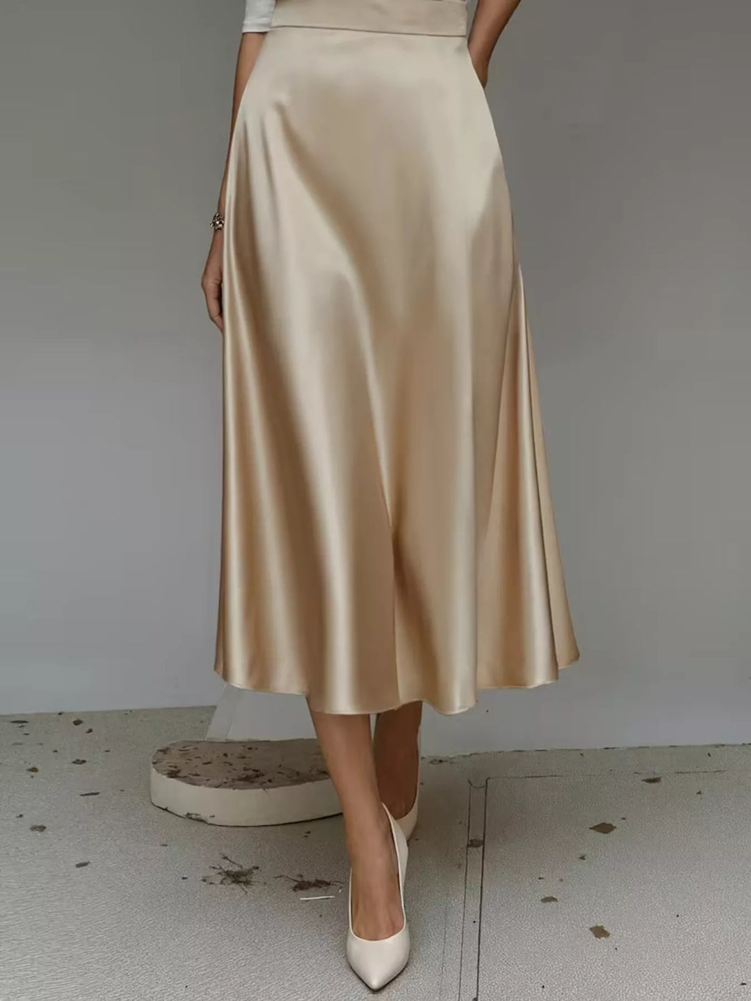 Back view of the champagne satin look midi skirt, high waisted
