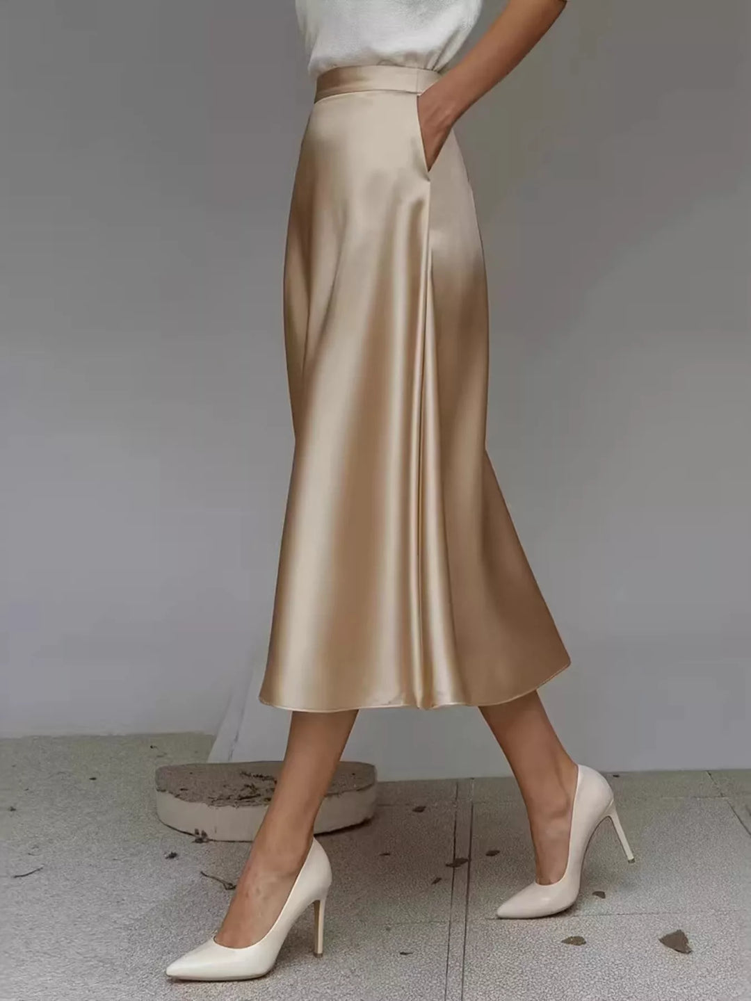 Side view of the champagne A line midi skirt while walking