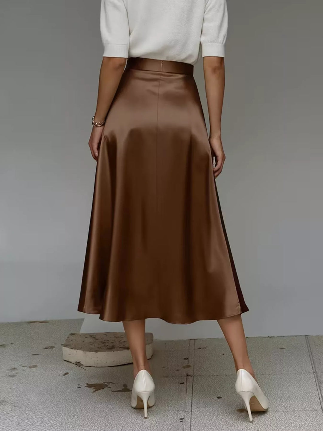Rear angle of the chocolate satin look midi skirt with a white top