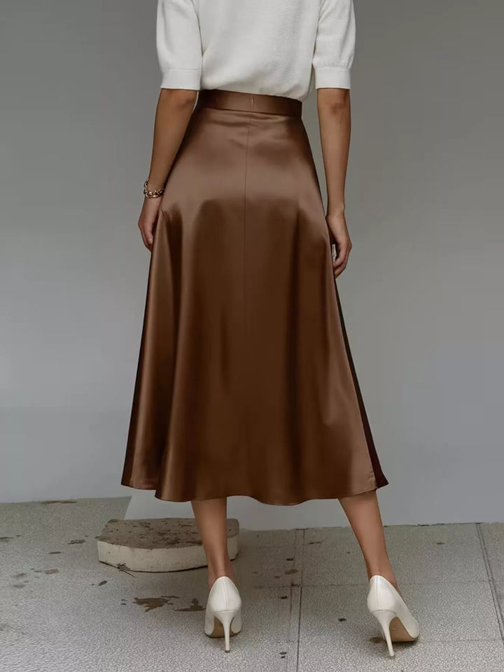 Rear angle of the chocolate satin look midi skirt with a white top