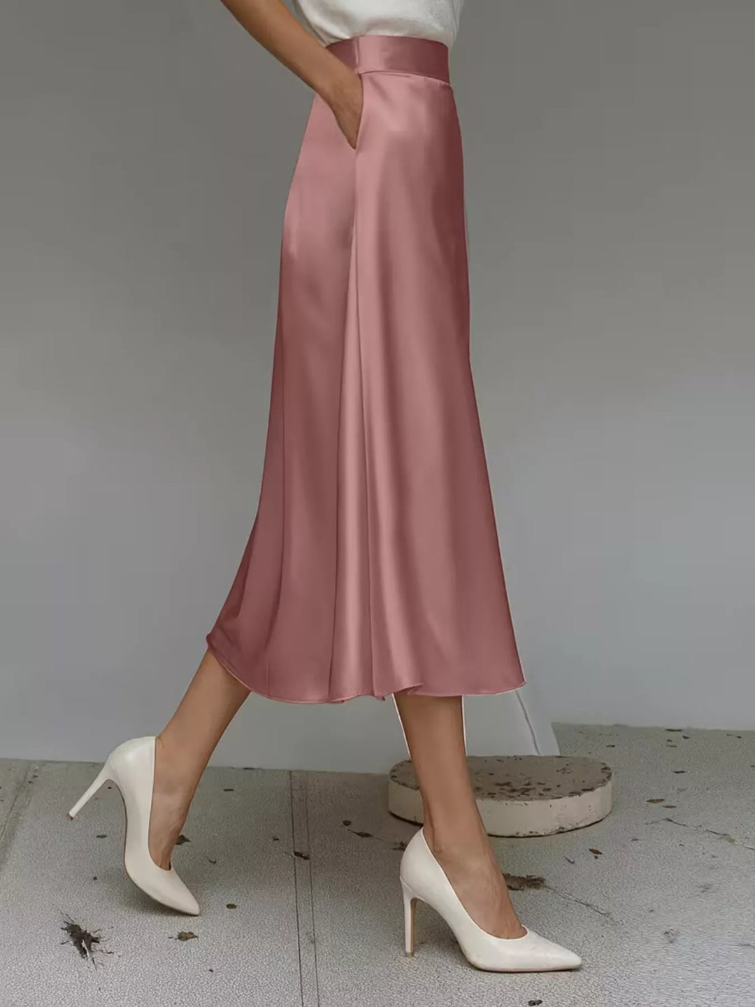 Side view of the dusty rose A line midi skirt with a hand in pocket