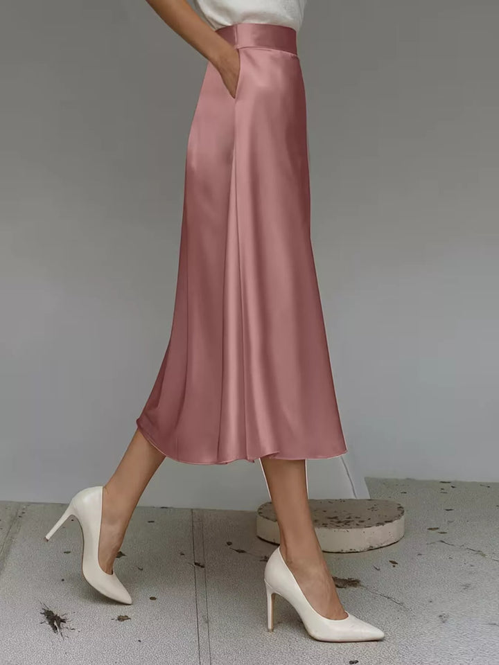 Side view of the dusty rose A line midi skirt with a hand in pocket