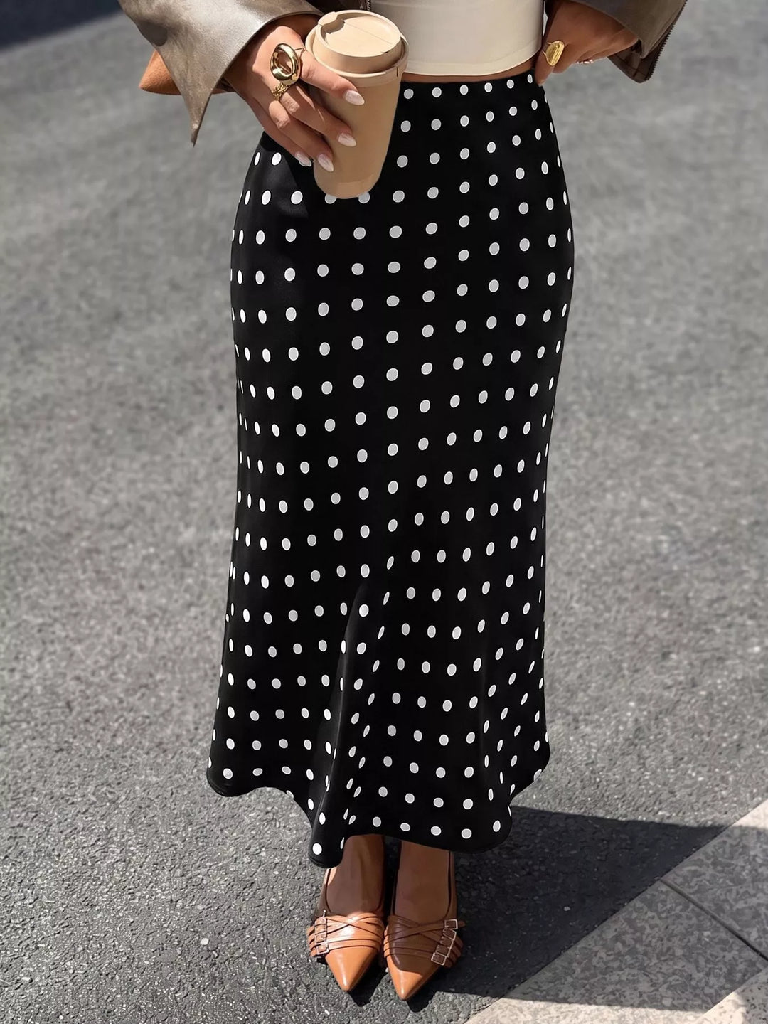 Black polka dot midi skirt worn with a leather jacket and slingback flats