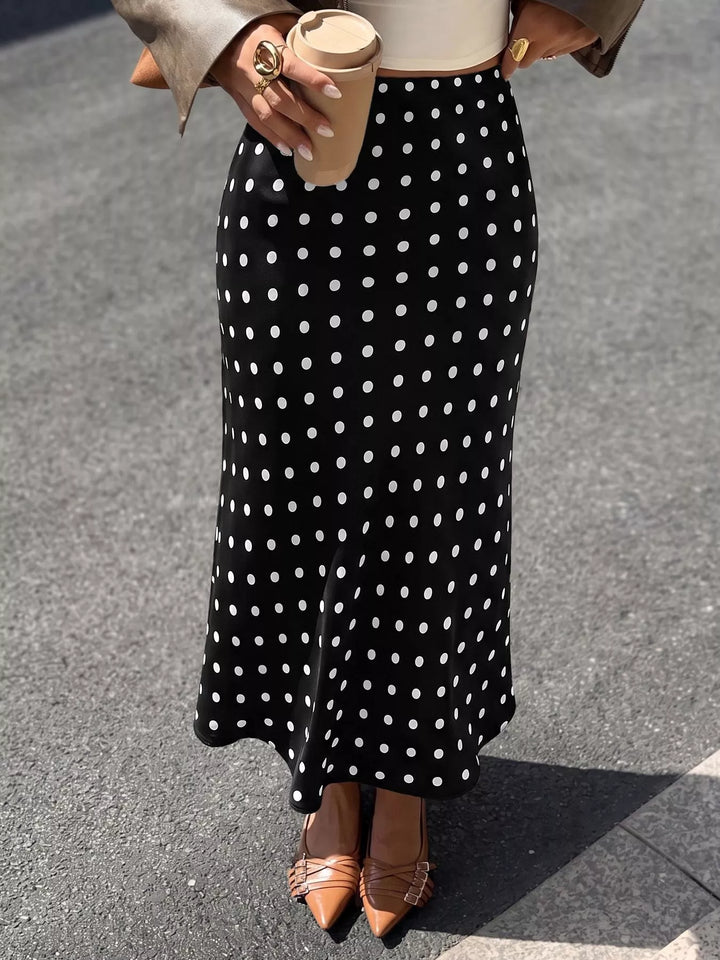 Black polka dot midi skirt worn with a leather jacket and slingback flats