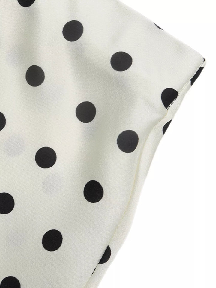 Cream skirt fabric draped to show the polka dot pattern and soft finish