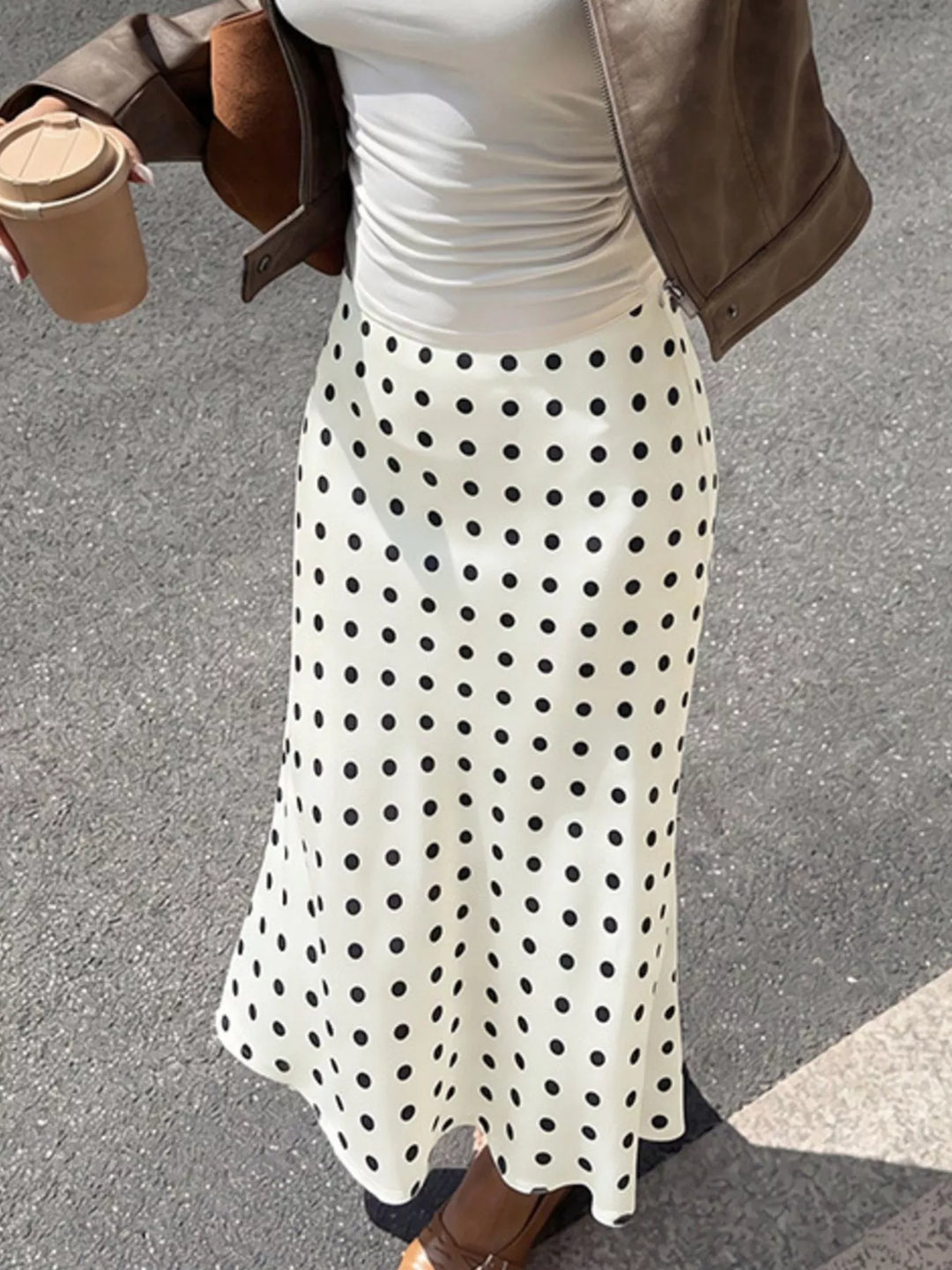 Cream polka dot skirt waist and flared hem, cropped torso view