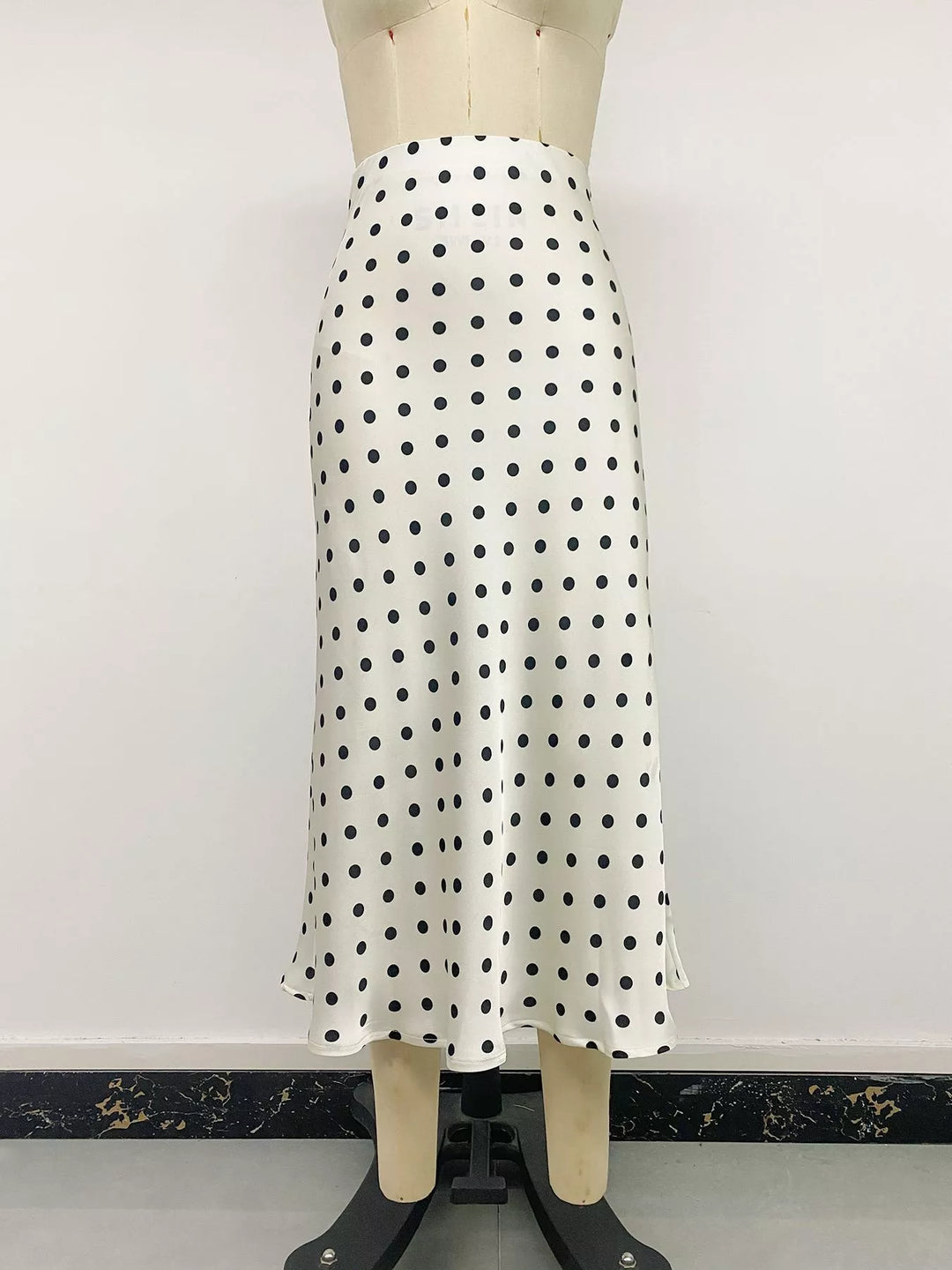 Cream polka dot midi skirt front view on a mannequin