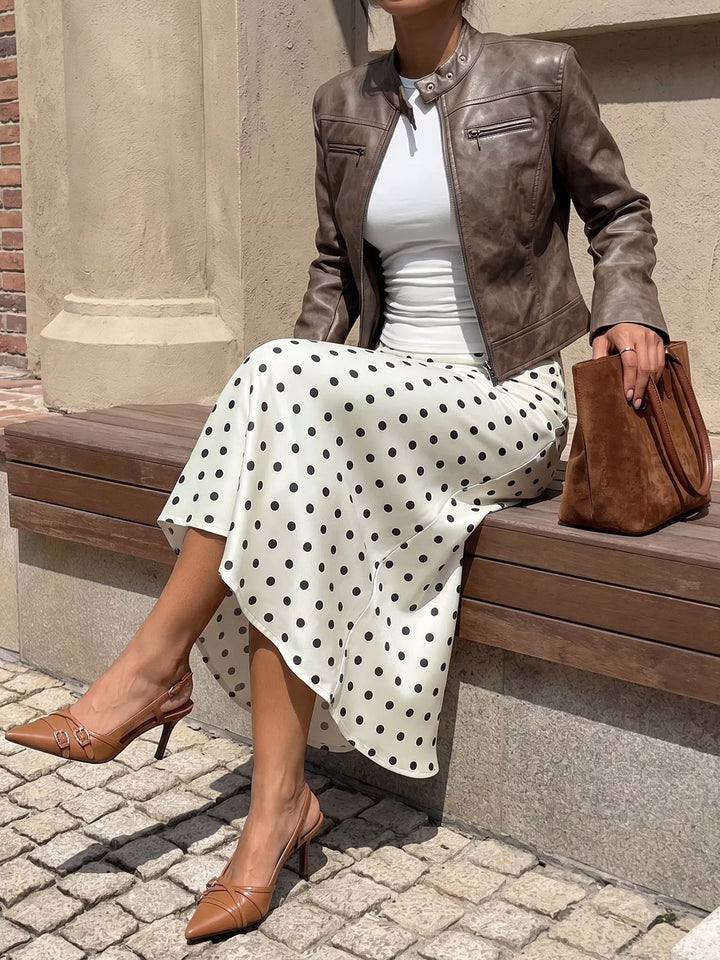 Seated pose in the cream polka dot skirt with brown slingback heels