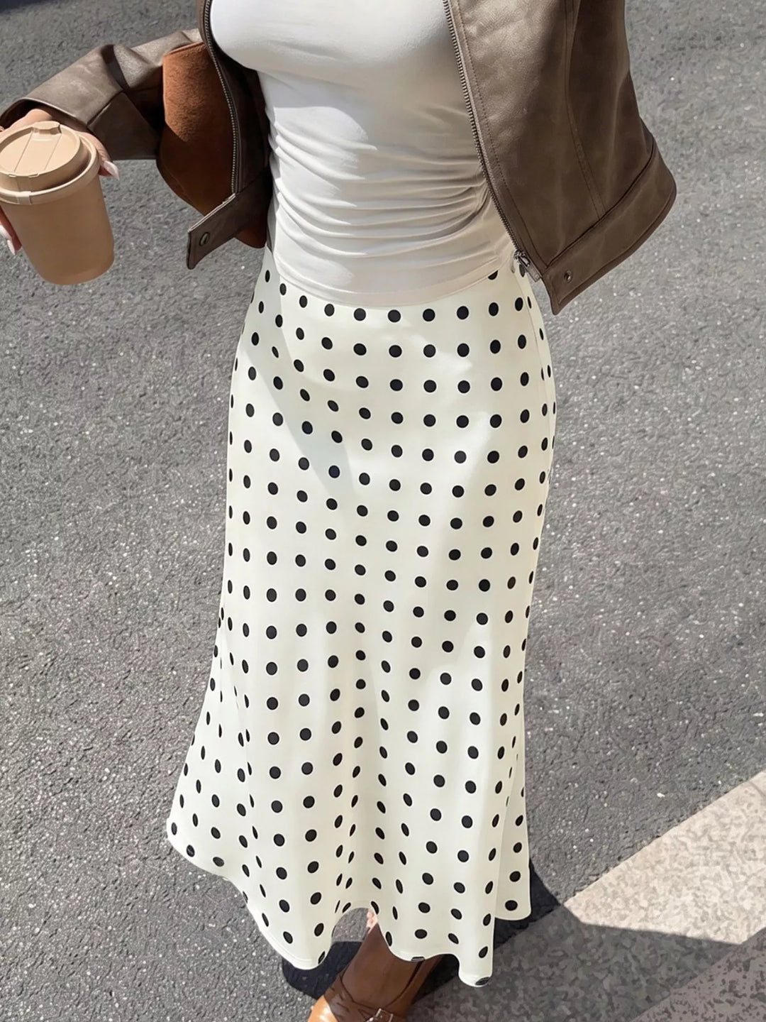Cream polka dot midi skirt styled with a gray tee and leather jacket