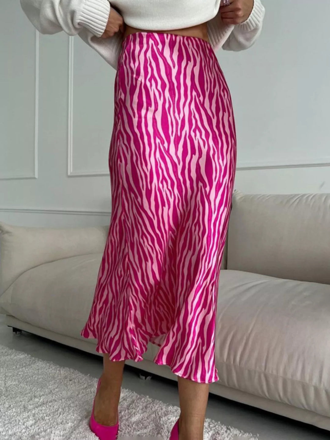 Hot pink zebra midi skirt showing the flared hem, three quarter view