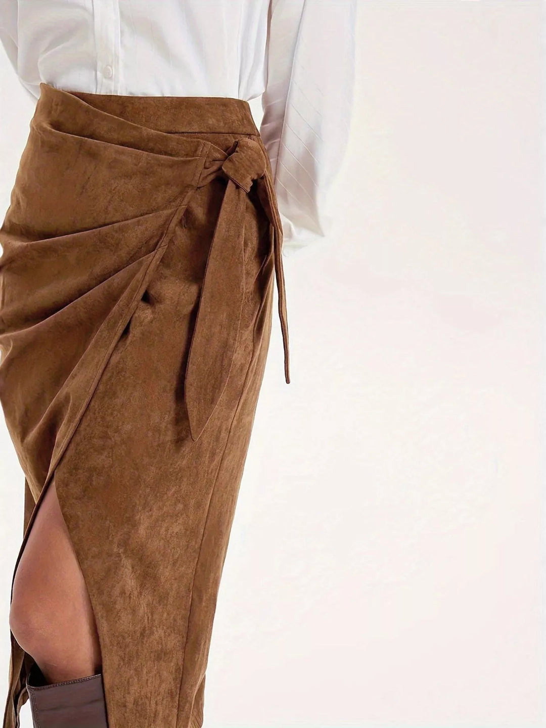 Close-up of the camel brown wrap skirt draped front and tied bow