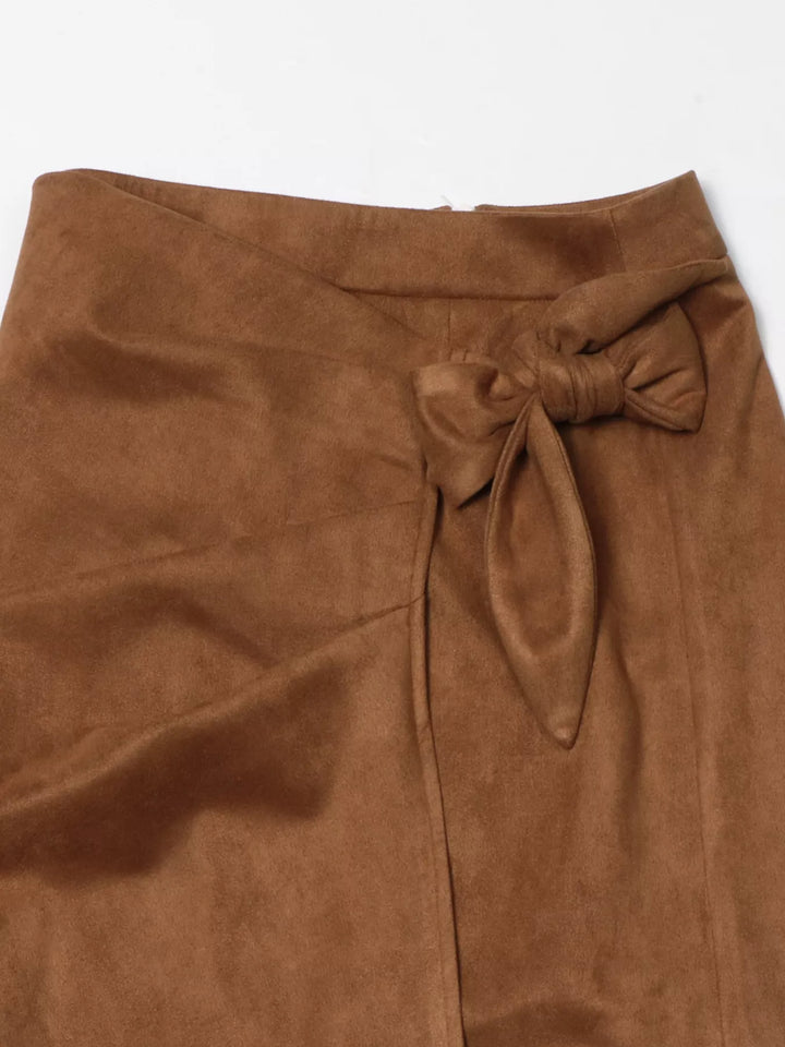 Detail of the camel brown wrap skirt bow tie at the waist