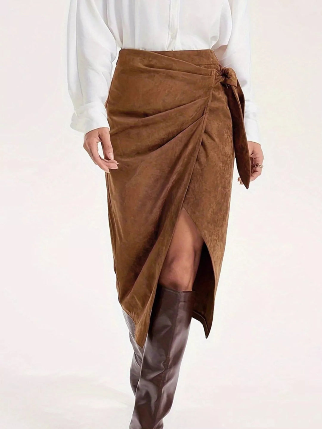 Front view of the suede-look wrap midi skirt with gathered tie and slit