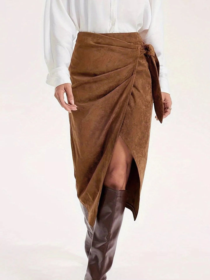 Front view of the suede-look wrap midi skirt with gathered tie and slit