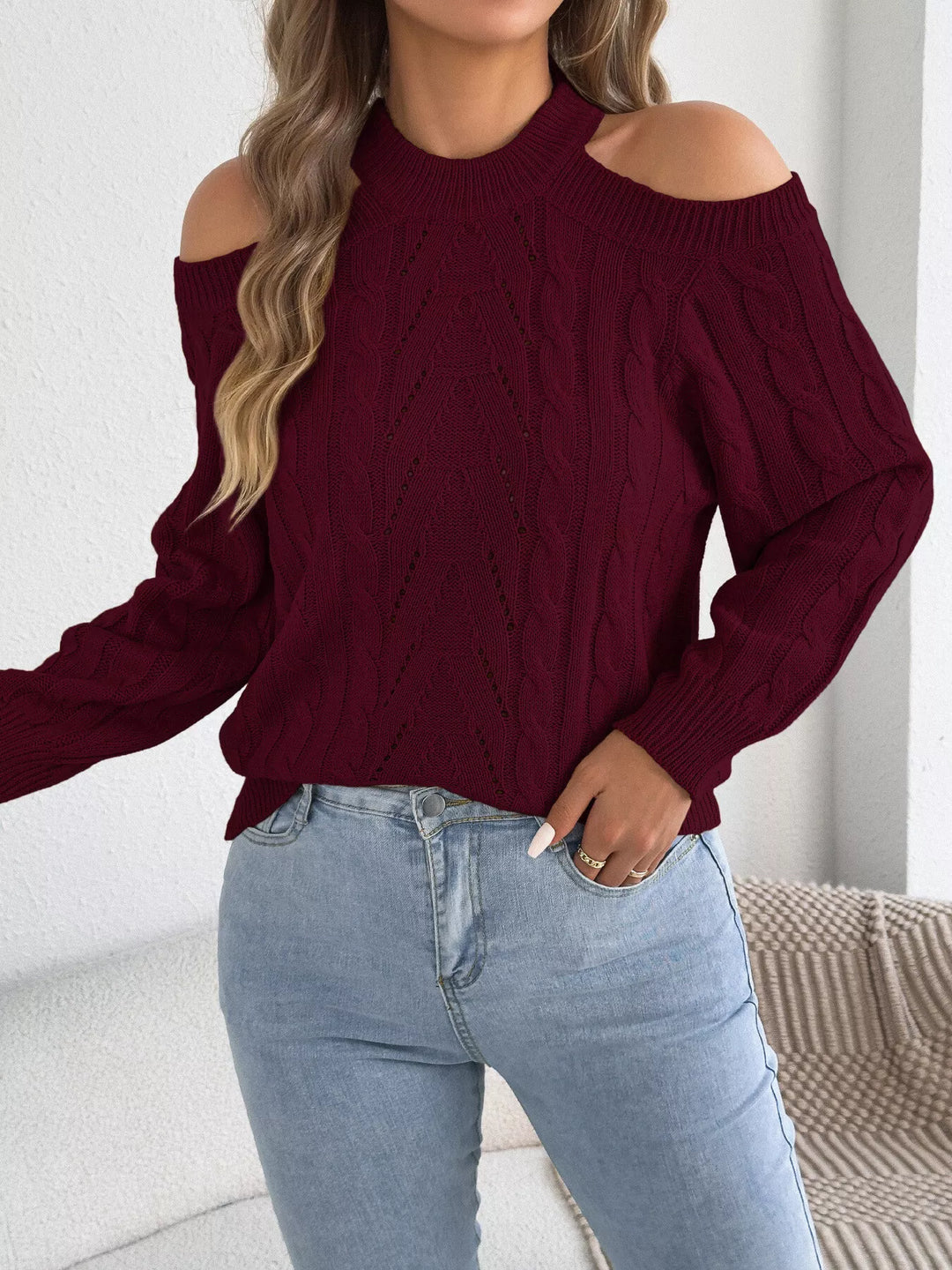 Burgundy cutout sweater in a turned pose showing sleeve volume