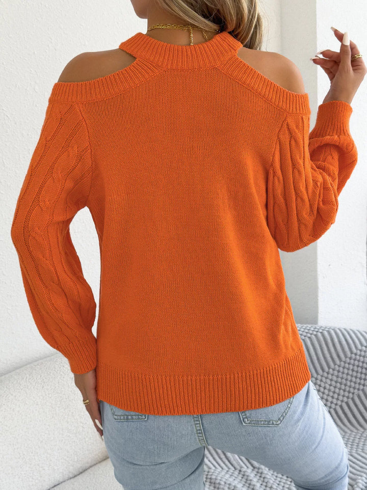 Back view of the orange mock neck sweater with cold shoulder cutouts