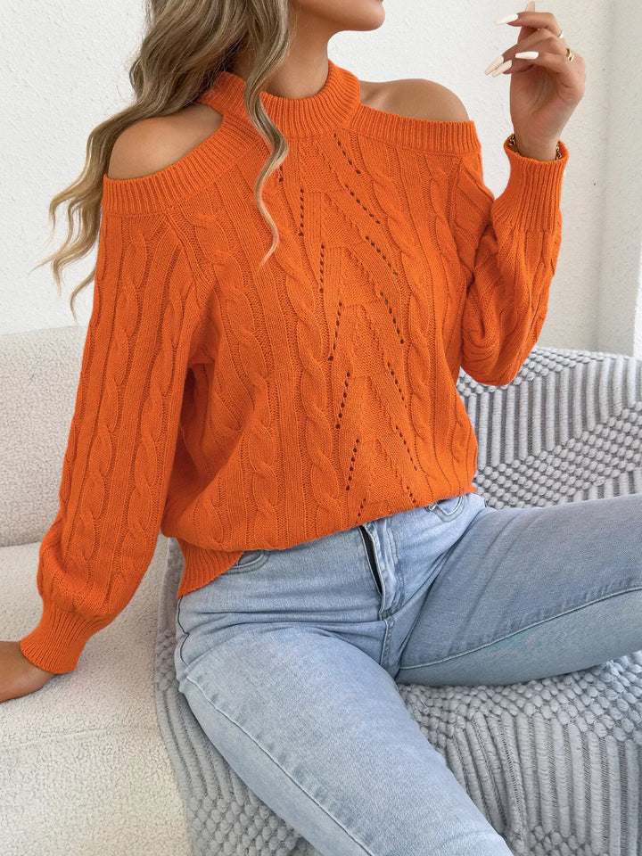 Women's mock neck sweater in orange with cable knit and cold shoulder cutouts
