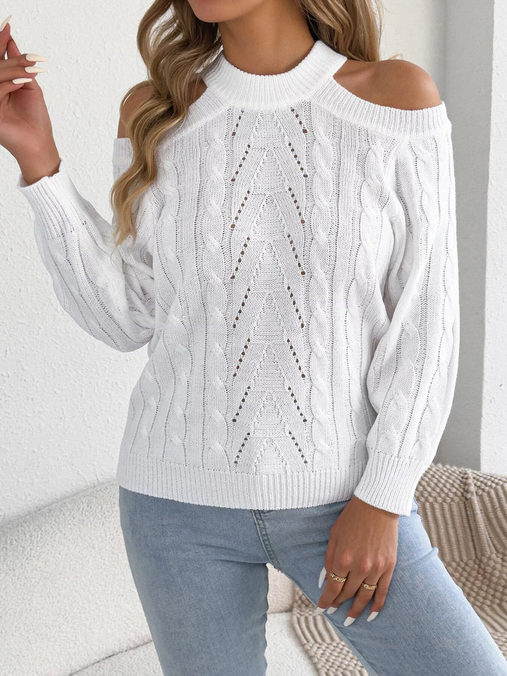 Close-up of the white cable knit sweater and ribbed cuffs