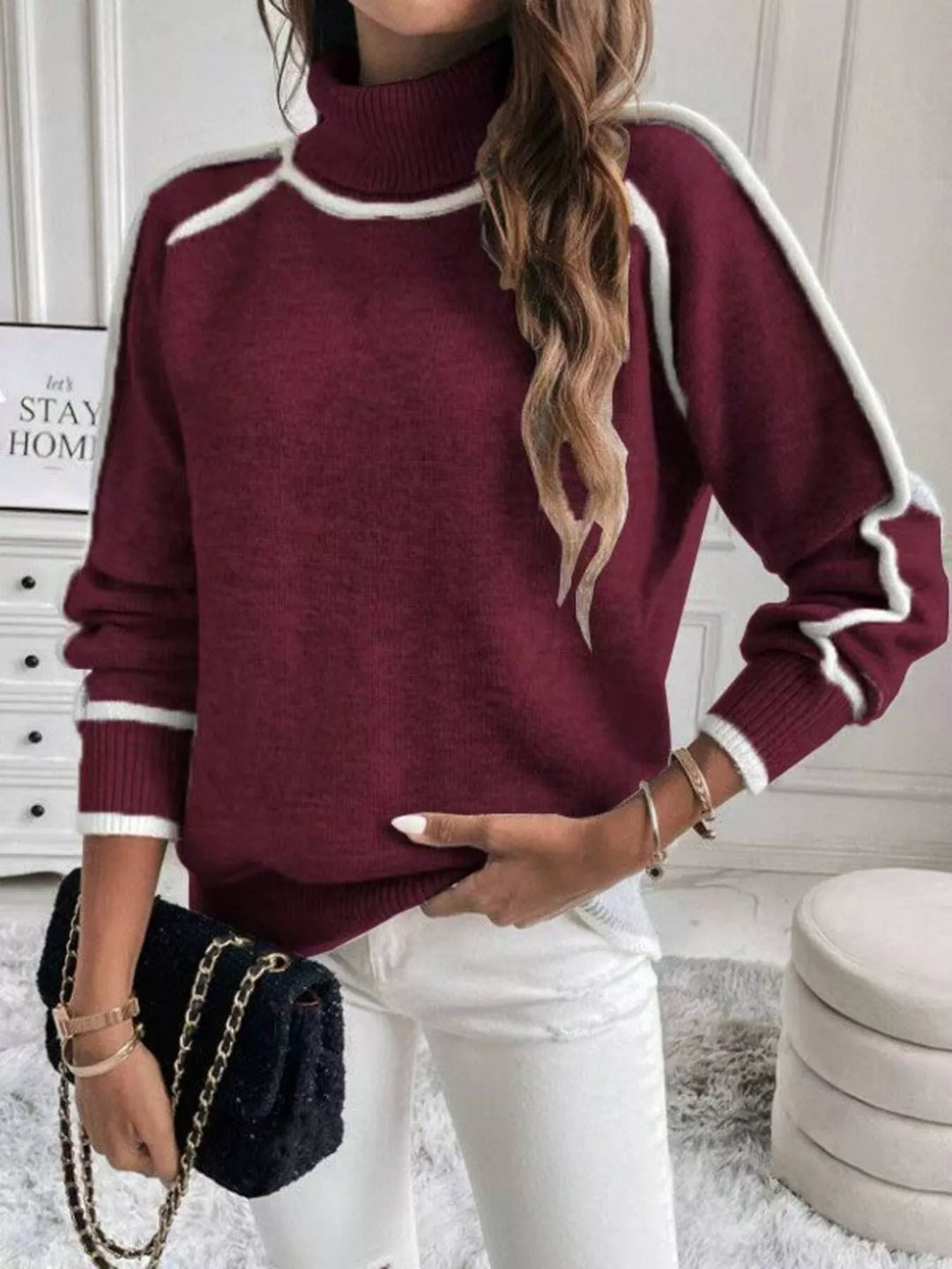 Wine mock neck sweater with white piping, styled with a black bag