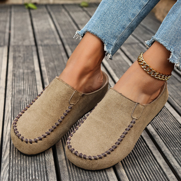 Beige backless loafer style mules seen from the front