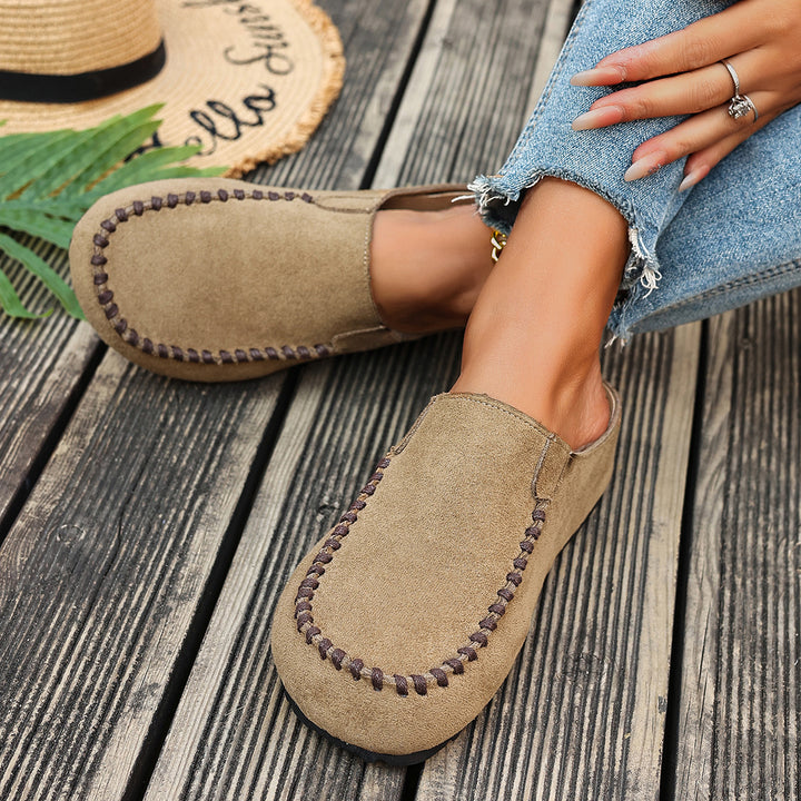 Pair of beige backless mules with stitched toe detail