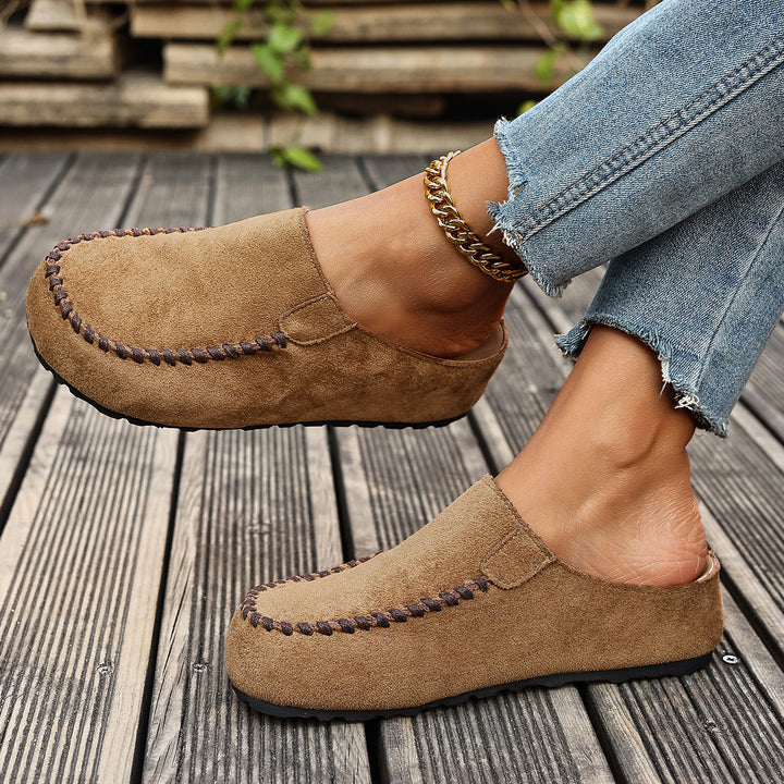 Tan slip on loafer style mules, side view