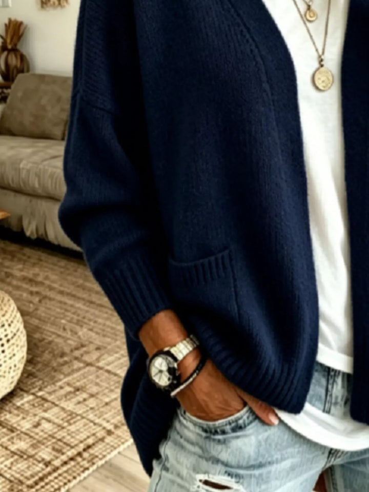 Close-up of the navy open front cardigan pocket and ribbed hem