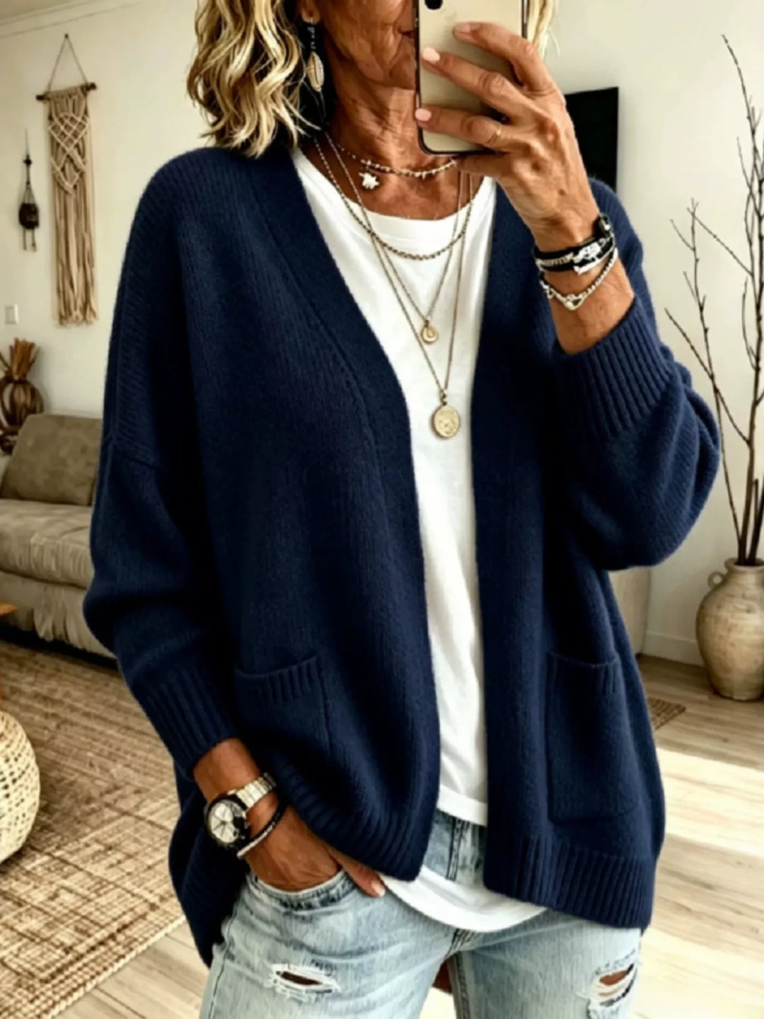 Navy oversized V neck cardigan worn open with layered necklaces and a white tee