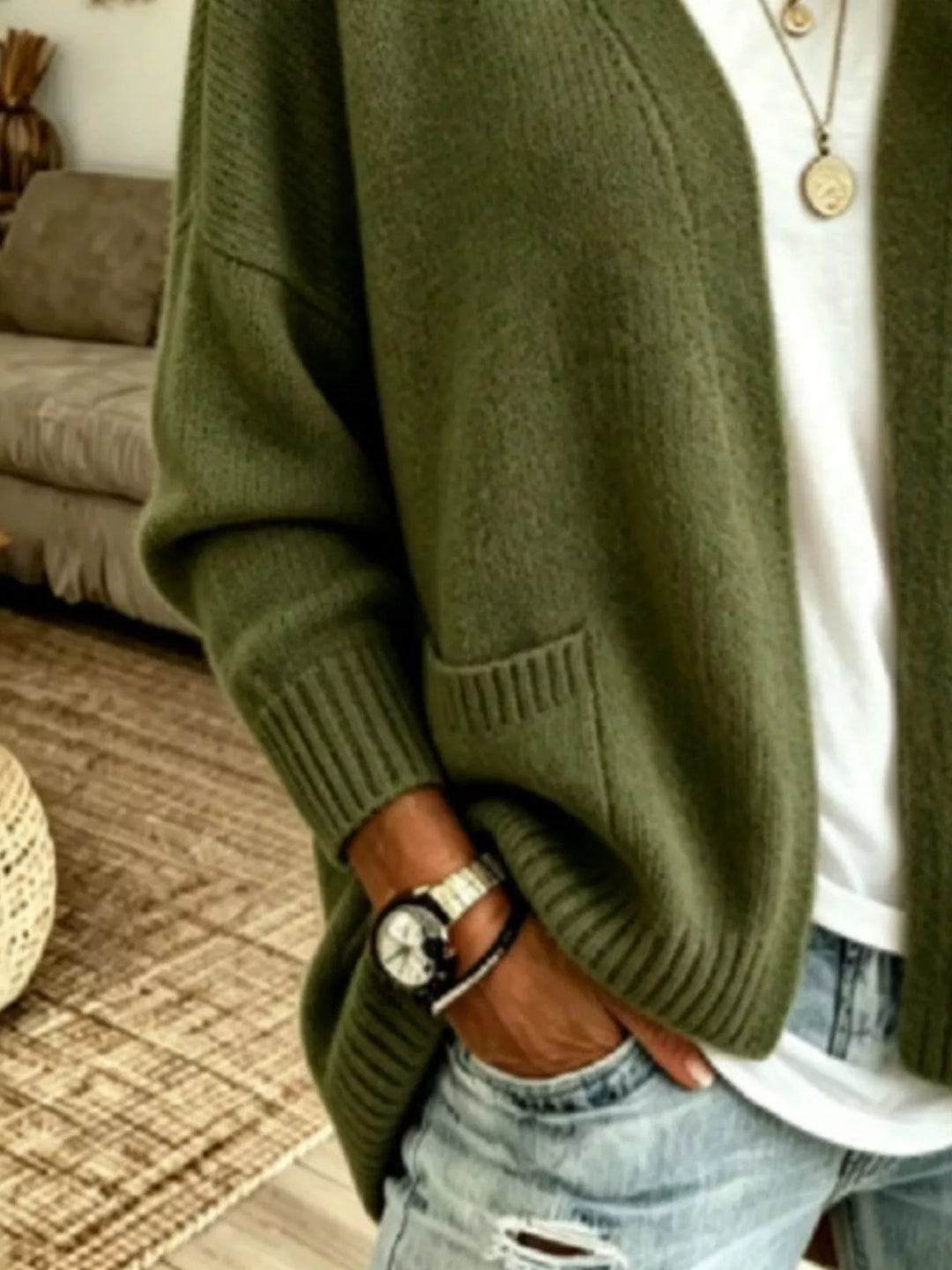 Close-up of the olive cardigan sleeve, ribbed cuff and pocket