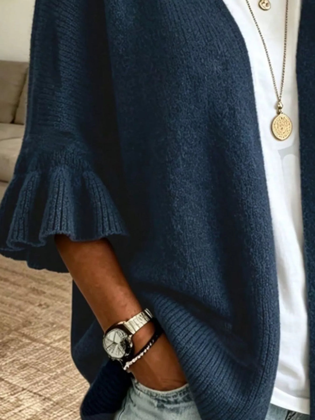 Navy cardigan close-up of the ruffled cuff and draped front