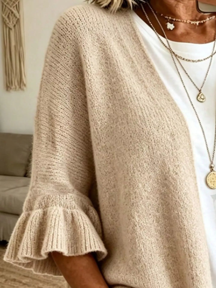 Close-up of the oatmeal knit cardigan ruffle sleeve and open front