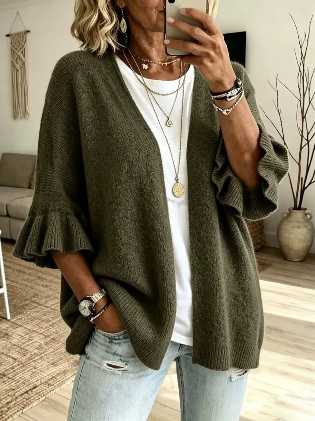 Olive green open front cardigan with ruffle cuffs styled with light jeans
