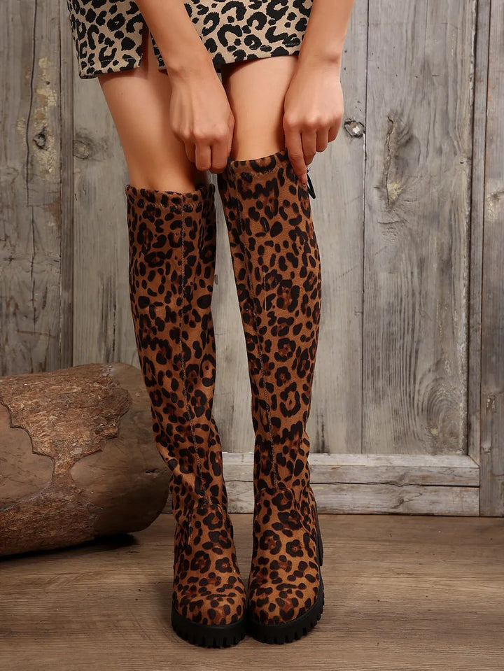 Front view of leopard print over the knee boots with a leopard skirt