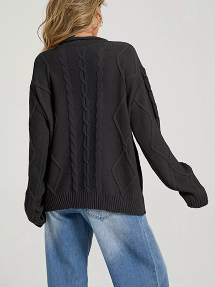 Back view of the black cable knit sweater with long sleeves