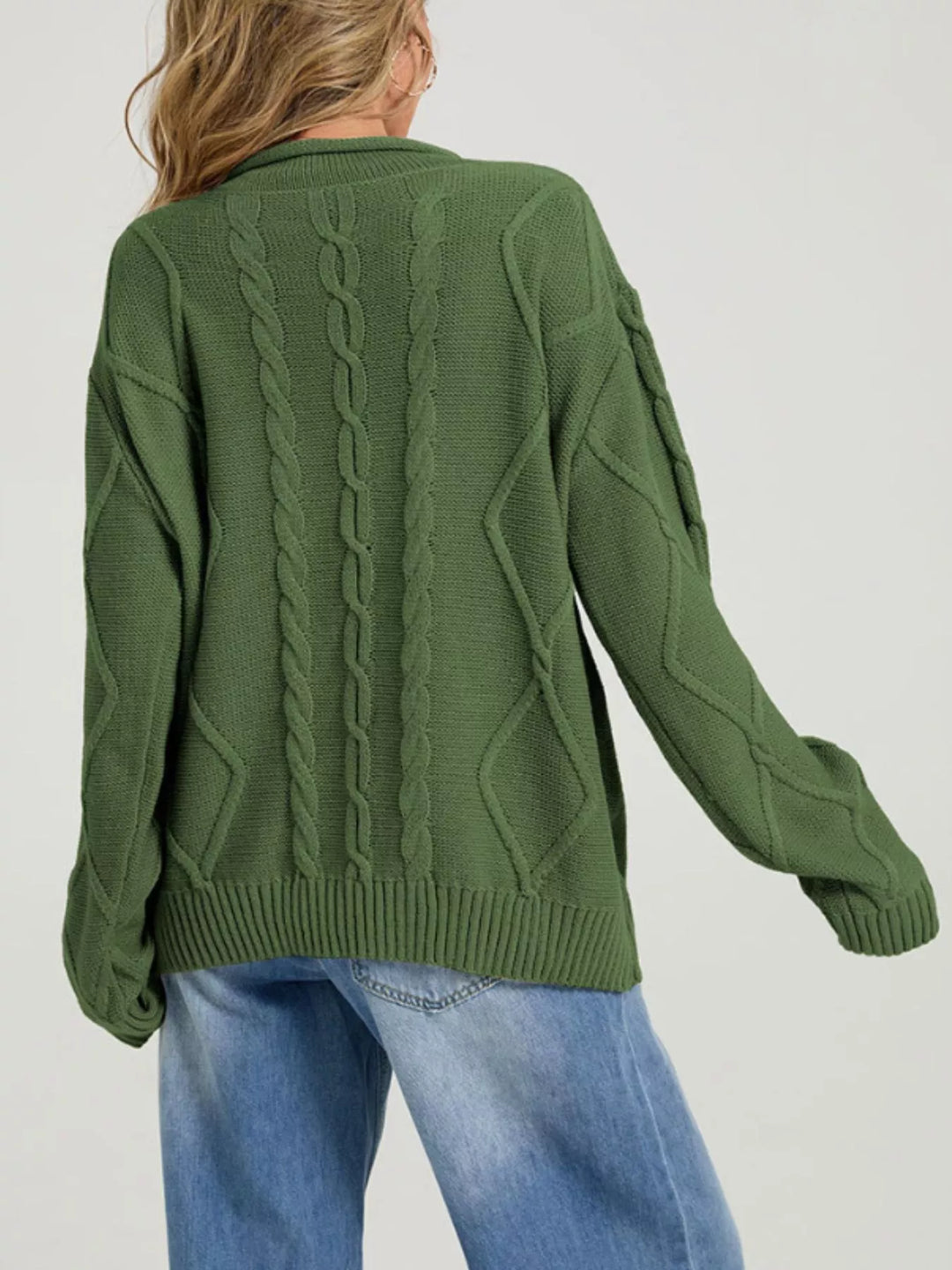 Back view of the forest green oversized sweater with cable knit pattern